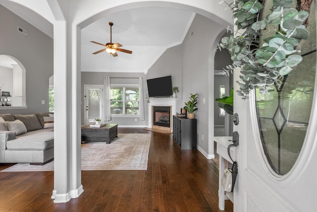 1398 Raven Rd, Clarksville, TN 37042 - foyer with a ceiling fan, lofted ceiling, dark wood-style flooring, a fireplace with raised hearth, and ornamental molding