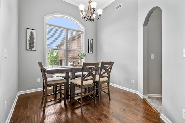 1398 Raven Rd, Clarksville, TN 37042 - dining area with arched walkways, dark wood finished floors, a chandelier, and crown molding