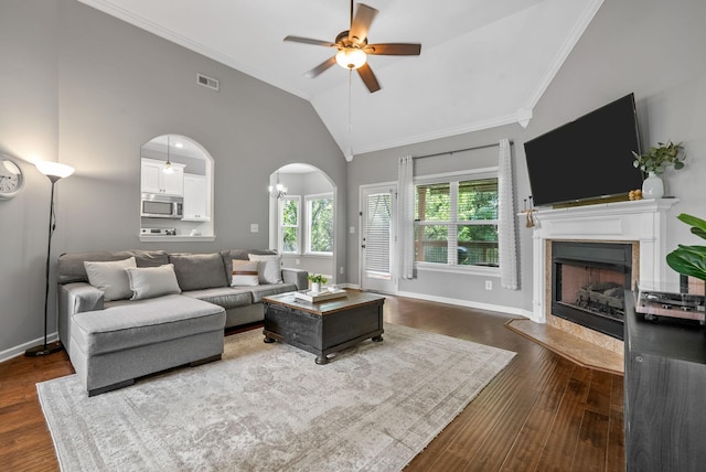 1398 Raven Rd, Clarksville, TN 37042 - living area featuring a fireplace with flush hearth, a ceiling fan, vaulted ceiling, dark wood-style flooring, and ornamental molding