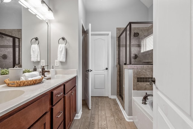 1398 Raven Rd, Clarksville, TN 37042 - bathroom featuring a stall shower, a bath, double vanity, and wood finished floors