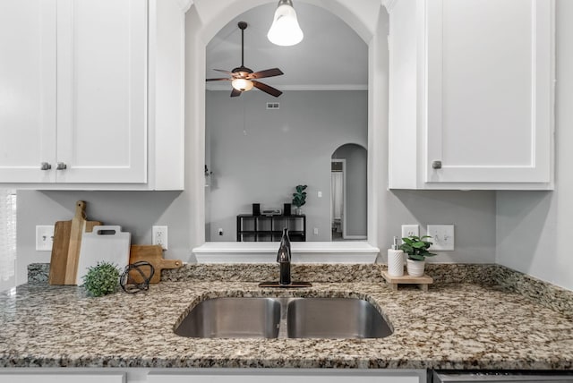 1398 Raven Rd, Clarksville, TN 37042 - kitchen featuring ceiling fan, arched walkways, white cabinetry, light stone counters, and crown molding
