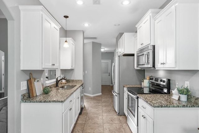 1398 Raven Rd, Clarksville, TN 37042 - kitchen featuring appliances with stainless steel finishes, white cabinetry, dark stone countertops, and recessed lighting