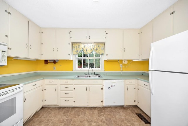 801 E Forrest St, Athens, AL 35611 - kitchen featuring white appliances, light countertops, and cream cabinets