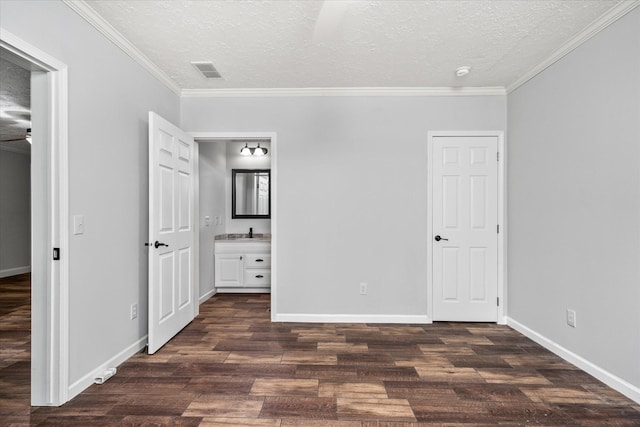 1901 Rickman Rd, Livingston, TN 38570 - unfurnished bedroom featuring a textured ceiling, dark wood finished floors, crown molding, and ensuite bath