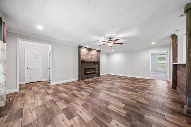 1901 Rickman Rd, Livingston, TN 38570 - unfurnished living room with ceiling fan, wood finished floors, a large fireplace, recessed lighting, and ornamental molding