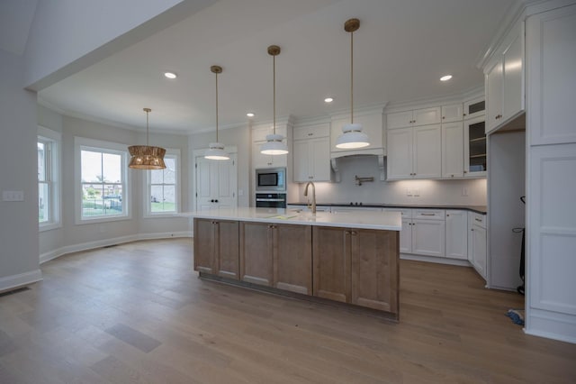 5077B Florence Rd, Murfreesboro, TN 37129 - kitchen featuring built in microwave, oven, wood finished floors, ornamental molding, and white cabinetry