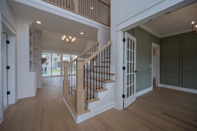 5077B Florence Rd, Murfreesboro, TN 37129 - stairway featuring a chandelier, wood finished floors, crown molding, ornate columns, and recessed lighting