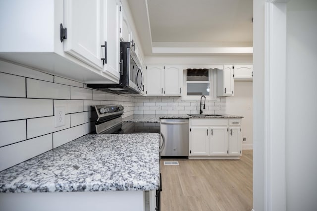 4037 Calumet Dr, Antioch, TN 37013 - kitchen with stainless steel appliances, backsplash, and white cabinets