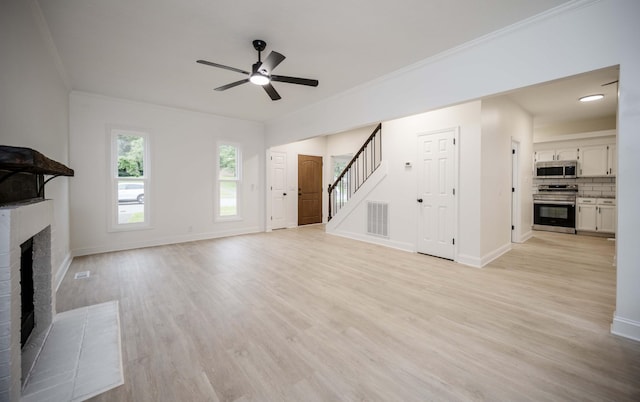 4037 Calumet Dr, Antioch, TN 37013 - unfurnished living room with a fireplace, ceiling fan, stairway, crown molding, and light wood-type flooring