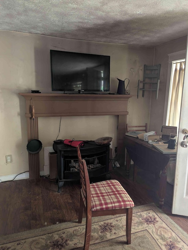 304 Fox Hollow Rd, Goodspring, TN 38460 - living room with a wood stove, wood finished floors, and a textured ceiling