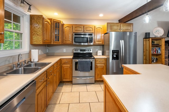 165 Kangaroo Ridge Rd, Byrdstown, TN 38549 - kitchen featuring appliances with stainless steel finishes, brown cabinets, glass insert cabinets, hanging light fixtures, and beam ceiling
