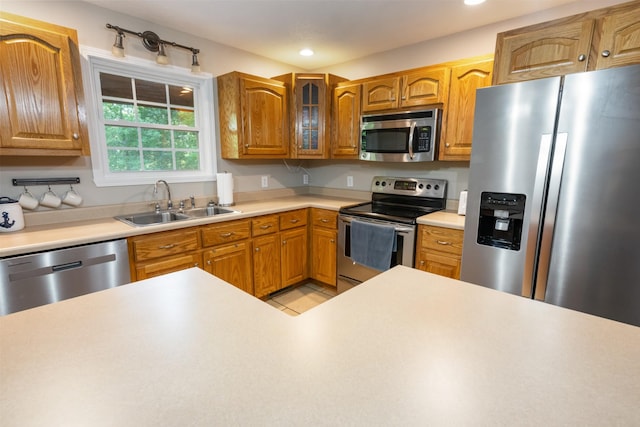 165 Kangaroo Ridge Rd, Byrdstown, TN 38549 - kitchen with stainless steel appliances, light countertops, recessed lighting, glass insert cabinets, and brown cabinets