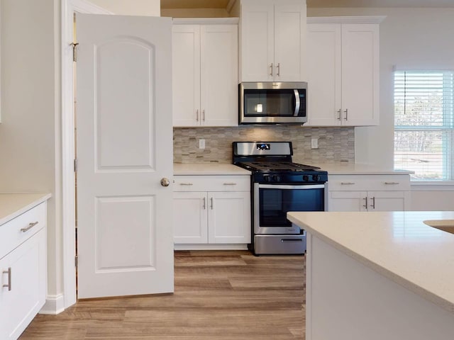 1334 Beasley Blvd, Mount Juliet, TN 37122 - kitchen featuring stainless steel appliances, light wood-type flooring, white cabinets, and light countertops