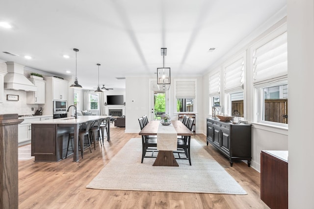 141 Foxhall Dr, Spring Hill, TN 37174 - dining space with healthy amount of natural light, a fireplace, light wood-style flooring, ceiling fan, and recessed lighting
