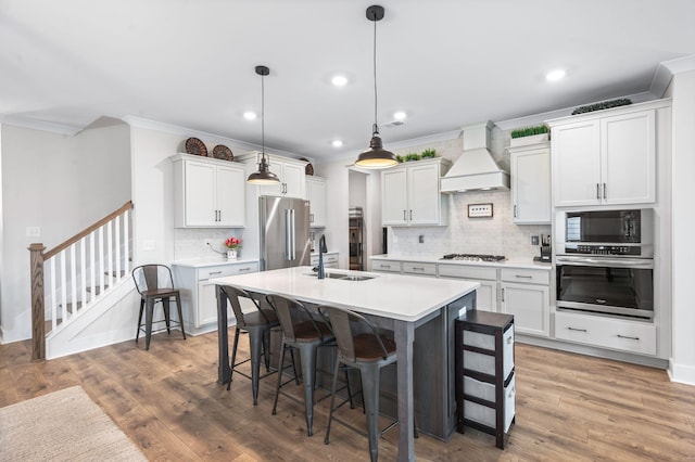 141 Foxhall Dr, Spring Hill, TN 37174 - kitchen featuring stainless steel appliances, crown molding, premium range hood, a breakfast bar area, and decorative backsplash