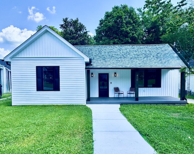 410 Washington Ave, Mount Pleasant, TN 38474 - view of front of property with a shingled roof, covered porch, a front yard, and board and batten siding