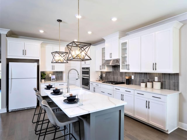 1332 Beasley Blvd, Mount Juliet, TN 37122 - kitchen featuring appliances with stainless steel finishes, under cabinet range hood, white cabinetry, dark wood-style floors, and recessed lighting