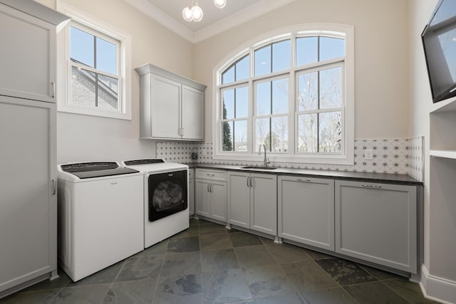 7521 Whiskey Rd, College Grove, TN 37046 - laundry room with washer and clothes dryer, healthy amount of natural light, cabinet space, and crown molding