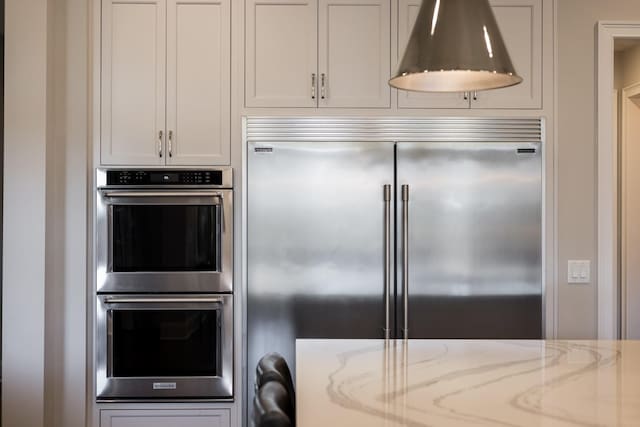 7521 Whiskey Rd, College Grove, TN 37046 - kitchen featuring appliances with stainless steel finishes and light stone counters
