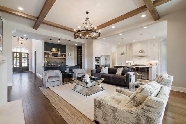 7521 Whiskey Rd, College Grove, TN 37046 - living room featuring a chandelier, beamed ceiling, recessed lighting, wood finished floors, and french doors