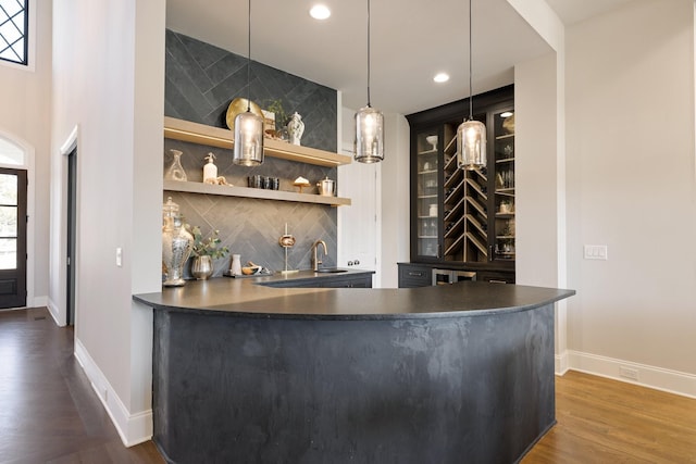7521 Whiskey Rd, College Grove, TN 37046 - indoor wet bar featuring decorative backsplash, dark wood finished floors, recessed lighting, pendant lighting, and built in features