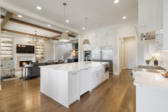 7521 Whiskey Rd, College Grove, TN 37046 - kitchen with white cabinetry, dark wood-style floors, a lit fireplace, appliances with stainless steel finishes, and recessed lighting