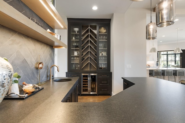 7521 Whiskey Rd, College Grove, TN 37046 - indoor wet bar with wine cooler, tasteful backsplash, hanging light fixtures, recessed lighting, and wood finished floors