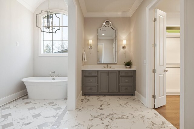 7521 Whiskey Rd, College Grove, TN 37046 - bathroom with a chandelier, vanity, a freestanding tub, marble finish floors, and crown molding