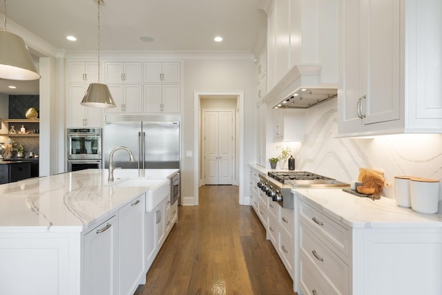 7521 Whiskey Rd, College Grove, TN 37046 - kitchen with stainless steel appliances, custom exhaust hood, backsplash, white cabinets, and a center island with sink
