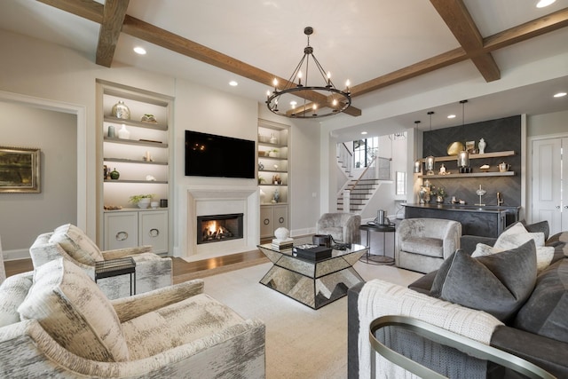 7521 Whiskey Rd, College Grove, TN 37046 - living area featuring stairway, beamed ceiling, a fireplace with flush hearth, recessed lighting, and a chandelier