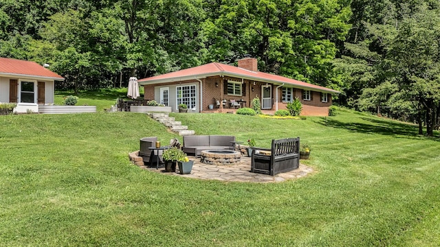 330 Cascade Hollow Rd, Normandy, TN 37360 - back of property with an outdoor fire pit, a chimney, a patio area, and a lawn