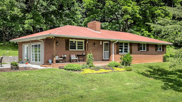 330 Cascade Hollow Rd, Normandy, TN 37360 - ranch-style house featuring a chimney, brick siding, a front yard, covered porch, and a metal roof