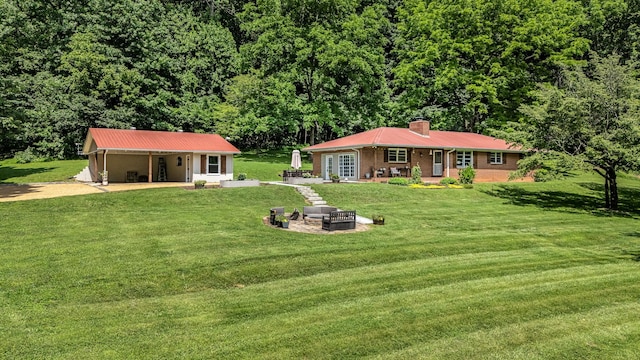 330 Cascade Hollow Rd, Normandy, TN 37360 - rear view of property with dirt driveway, a lawn, a chimney, a fire pit, and an attached carport