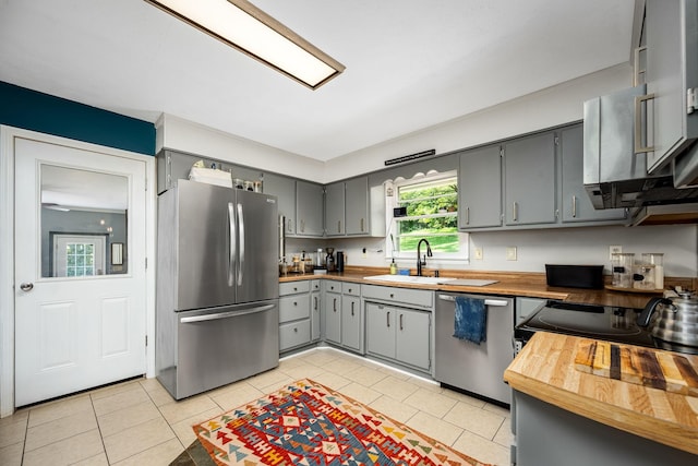 330 Cascade Hollow Rd, Normandy, TN 37360 - kitchen featuring appliances with stainless steel finishes, gray cabinets, light tile patterned floors, and wood counters