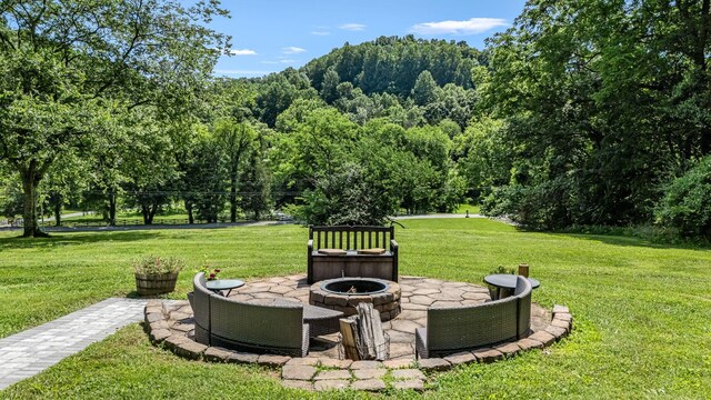 330 Cascade Hollow Rd, Normandy, TN 37360 - view of grassy yard with a fire pit, a forest view, and a patio