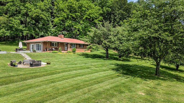 330 Cascade Hollow Rd, Normandy, TN 37360 - view of front of house featuring a fire pit, a chimney, a patio, and a front lawn