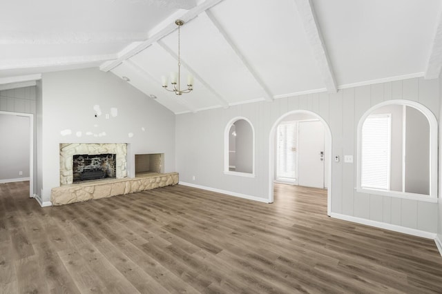 4052 Port Cleburne Ln, Hermitage, TN 37076 - unfurnished living room featuring wood finished floors, a fireplace, a chandelier, and arched walkways