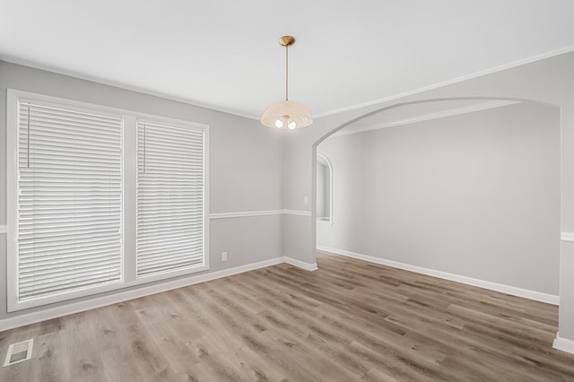 4052 Port Cleburne Ln, Hermitage, TN 37076 - unfurnished dining area with arched walkways, wood finished floors, and ornamental molding