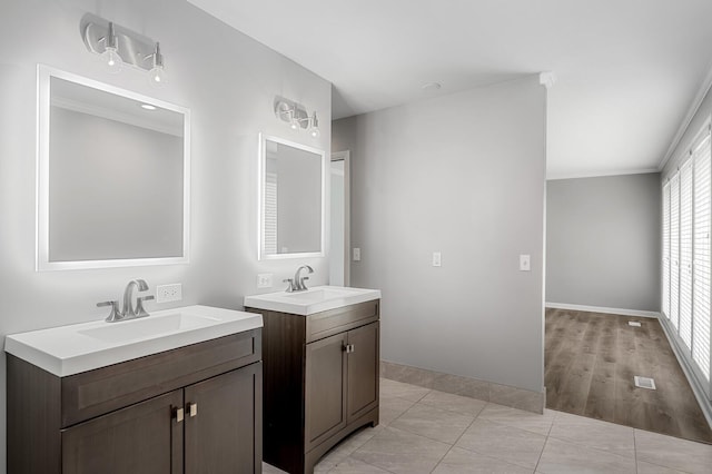 4052 Port Cleburne Ln, Hermitage, TN 37076 - bathroom featuring two vanities, ornamental molding, and tile patterned flooring