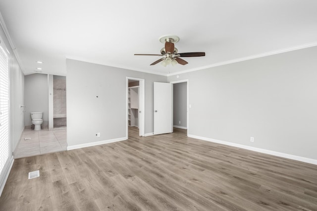 4052 Port Cleburne Ln, Hermitage, TN 37076 - unfurnished bedroom featuring a walk in closet, crown molding, wood finished floors, a closet, and ensuite bathroom