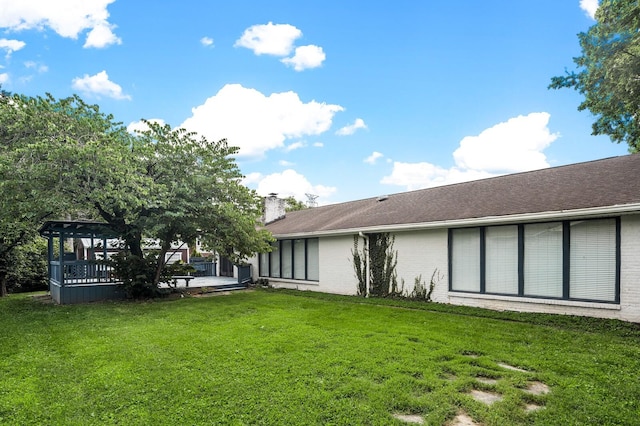 4052 Port Cleburne Ln, Hermitage, TN 37076 - rear view of house with brick siding, a chimney, a yard, and a deck