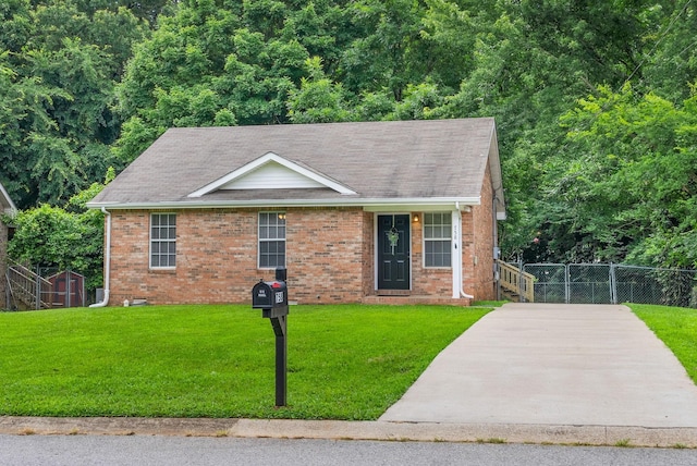 758 Spees Dr, Clarksville, TN 37042 - view of front facade featuring brick siding, a storage unit, and roof with shingles