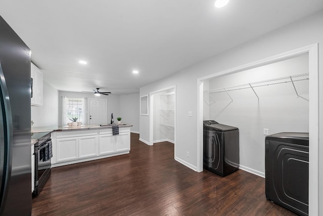 758 Spees Dr, Clarksville, TN 37042 - kitchen featuring a peninsula, washing machine and clothes dryer, black range with electric cooktop, white cabinetry, and recessed lighting