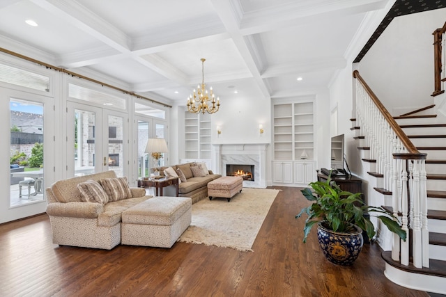 813 Stonewater Blvd, Franklin, TN 37064 - living room featuring stairway, dark wood-type flooring, ornamental molding, built in shelves, and french doors