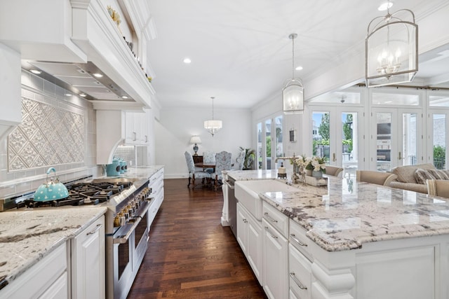 813 Stonewater Blvd, Franklin, TN 37064 - kitchen featuring range with two ovens, a chandelier, crown molding, dark wood-style flooring, and extractor fan