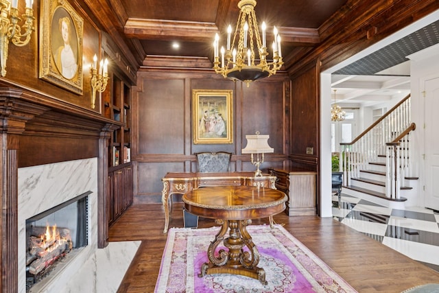 813 Stonewater Blvd, Franklin, TN 37064 - dining area featuring a chandelier, coffered ceiling, dark wood finished floors, crown molding, and a premium fireplace