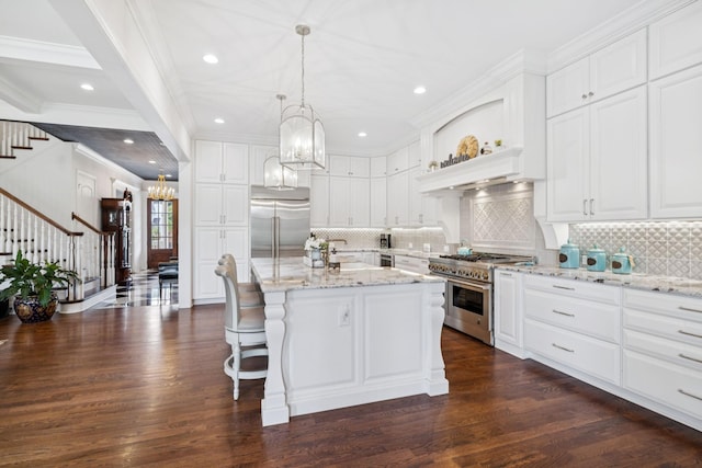 813 Stonewater Blvd, Franklin, TN 37064 - kitchen featuring premium appliances, ornamental molding, a chandelier, dark wood-style flooring, and tasteful backsplash
