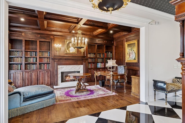 813 Stonewater Blvd, Franklin, TN 37064 - living room featuring wood walls, built in shelves, a premium fireplace, crown molding, and coffered ceiling