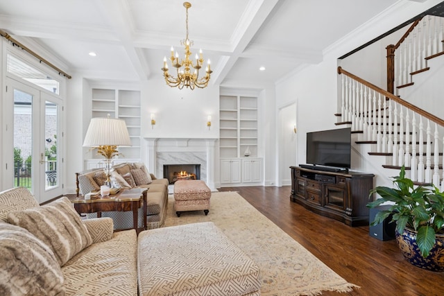 813 Stonewater Blvd, Franklin, TN 37064 - living room featuring built in shelves, dark wood-style flooring, stairs, beam ceiling, and crown molding