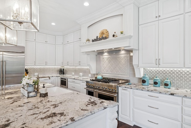 813 Stonewater Blvd, Franklin, TN 37064 - kitchen with high quality appliances, white cabinets, backsplash, and recessed lighting
